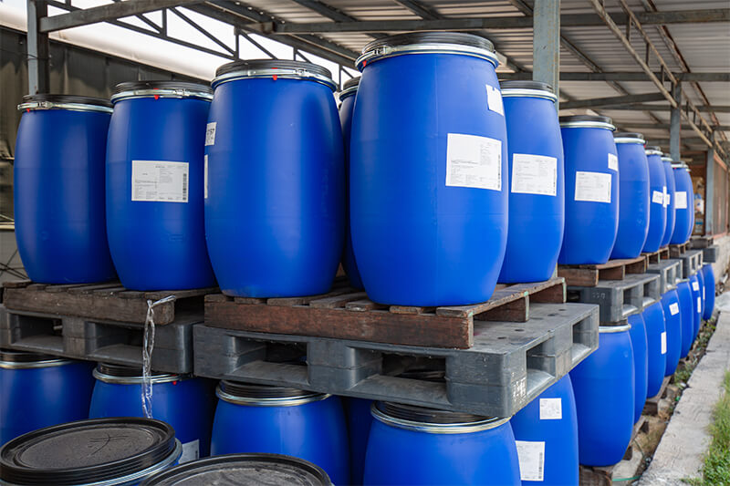 inventory of chemicals in plastic barrels on pallets